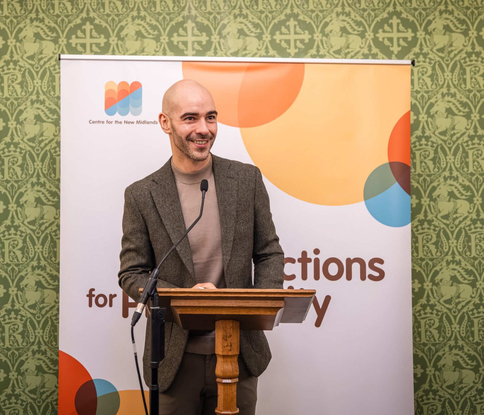 Leon speaking at a lectern